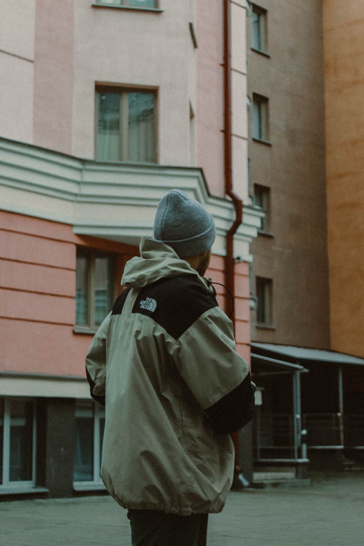 Layered winter streetwear outfit with a beanie