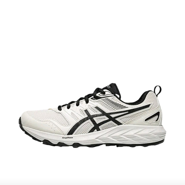 White athletic shoe with black accents and laces, featuring a textured sole and mesh fabric.