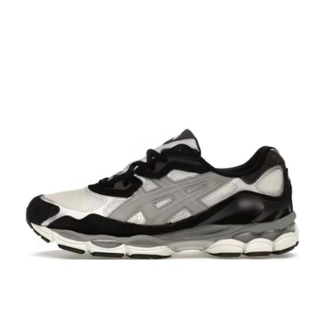 Black and white sneaker with mesh upper, gray accents, and a textured white sole.