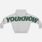 Light gray pattern with green lettering