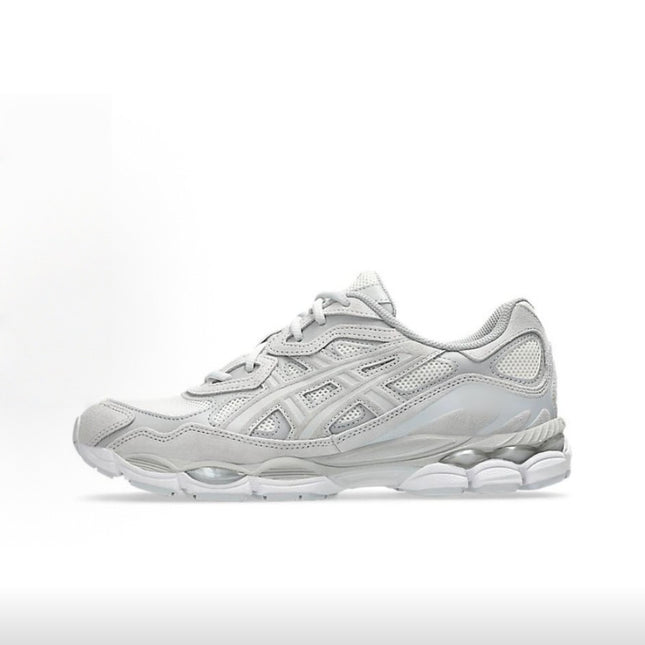 Silver athletic sneaker with mesh panels, textured sole, and white laces on a white background.