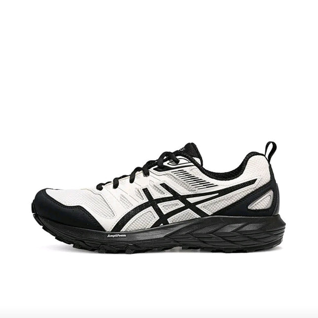 White and black athletic shoe with mesh texture, black laces, and a thick sole.