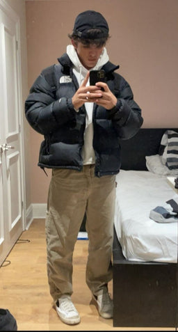 Streetwear outfit featuring a black TNF puffer jacket